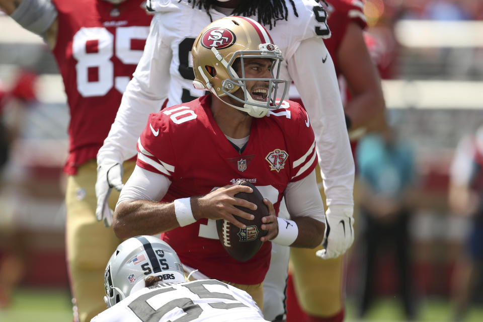 San Francisco 49ers quarterback Jimmy Garoppolo, center, reacts after scoring against the Las Vegas Raiders during the first half of an NFL preseason football game in Santa Clara, Calif., Sunday, Aug. 29, 2021. (AP Photo/Jed Jacobsohn)