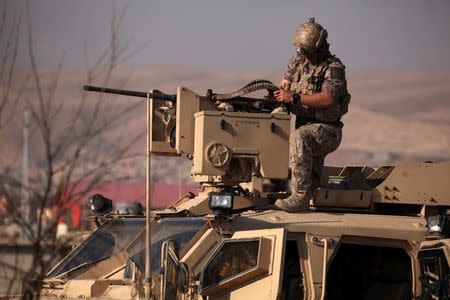 An American soldier sits in a military vehicle in the town of Bashiqa, east of Mosul, during an operation to attack Islamic State militants in Mosul, Iraq, November 7, 2016. REUTERS/Azad Lashkari