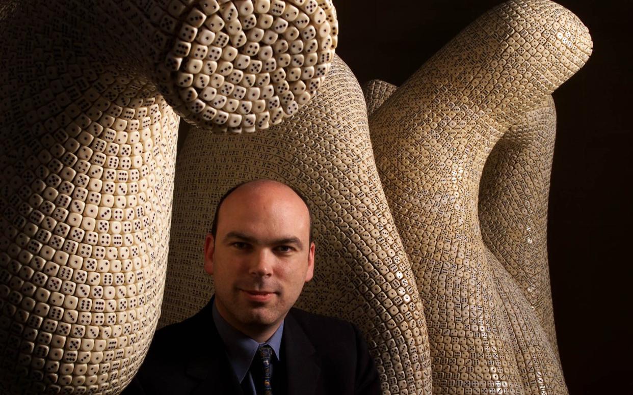 Lynch with a sculpture made from dice in 2000