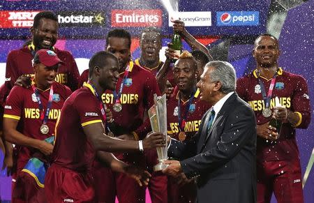 Cricket - England v West Indies - World Twenty20 cricket tournament final - Kolkata, India - 03/04/2016. West Indies captain Darren Sammy (3rd L) receives the trophy from Zaheer Abbas, President of International Cricket Council (ICC), after they won the final. REUTERS/Adnan Abidi