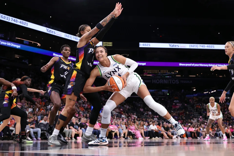  Kayla McBride #21 of the Minnesota Lynx drives into Natasha Cloud #0 of the Phoenix Mercury during the first half at Footprint Center on August 28, 2024 in Phoenix, Arizona.The Lynx defeated the Mercury 89-76.  NOTE TO USER: User expressly acknowledges and agrees that, by downloading and or using this photograph, User is consenting to the terms and conditions of the Getty Images License Agreement.  (Photo by Chris Coduto/Getty Images)