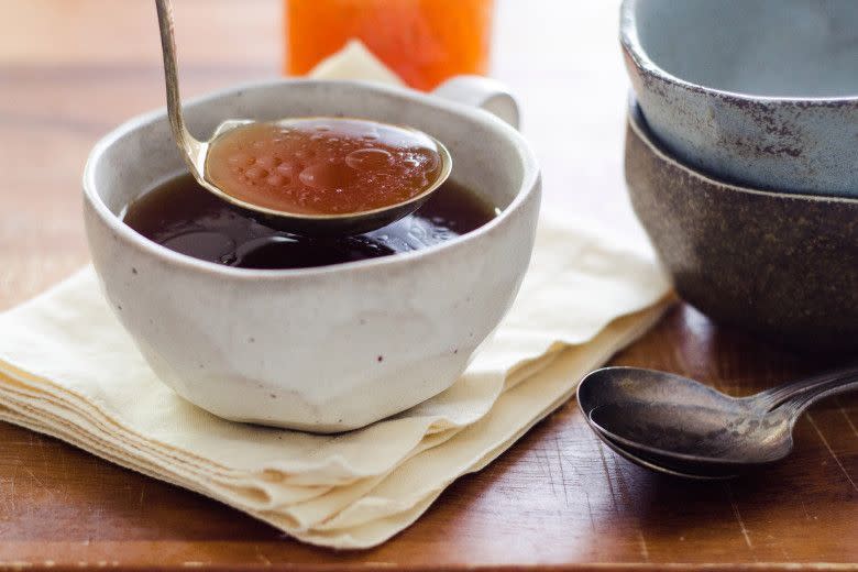 homemade beef broth with ladle