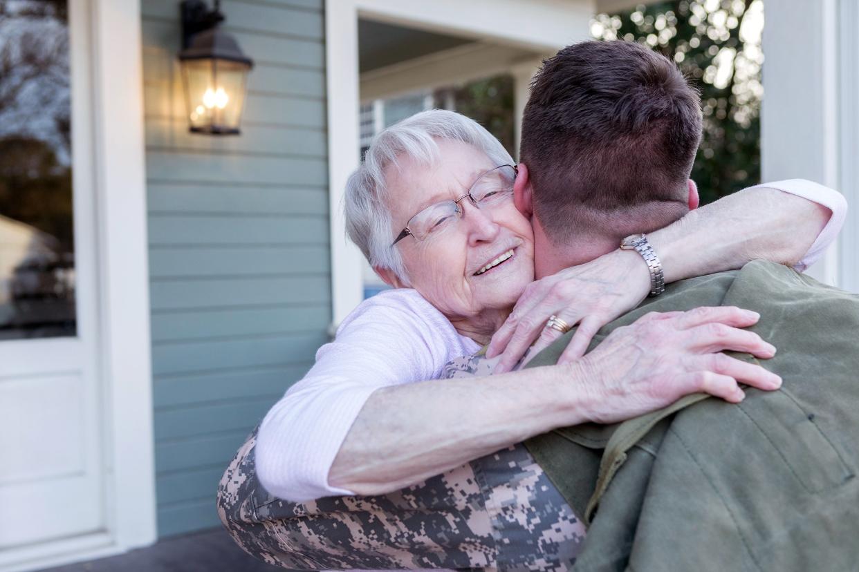 excited senior mom is happy son is home from deployment