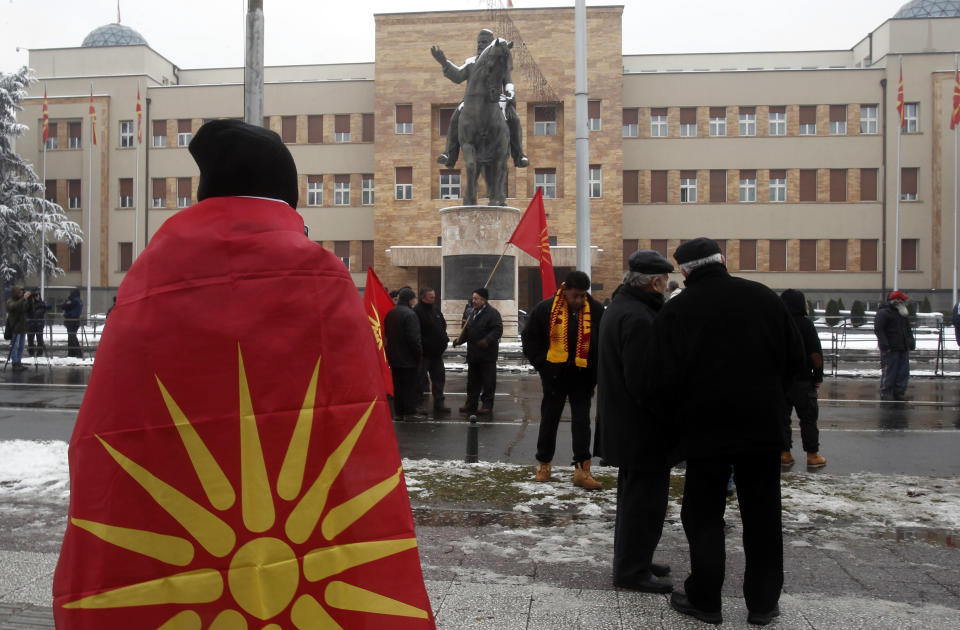 People gather to a protest against the change of the country's name outside the parliament building during a session of the Macedonian Parliament in the capital Skopje, Friday, Jan. 11, 2019. Macedonia has fulfilled its part of a deal that will pave its way to NATO membership and normalize relations with neighboring Greece, after lawmakers approved constitutional changes that will rename the country North Macedonia. (AP Photo/Boris Grdanoski)
