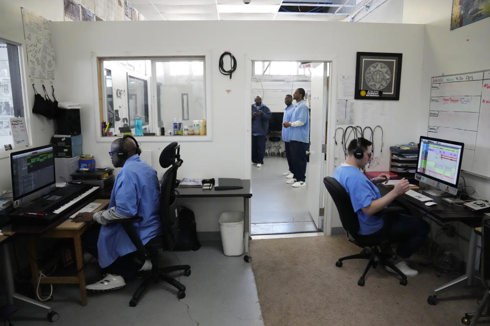 Incarcerated men Steven Rhashiyd Zinnamon, left, and Tony Tafoy, right, work in the Ear Hustle podcasting studio at San Quentin State Prison in San Quentin, Calif., Friday, March 17, 2023. Gov. Gavin Newsom plans to transform San Quentin State Prison, a facility in the San Francisco Bay Area known for maintaining the highest number of prisoners on death row in the country. Newsom said his goal is to turn the prison into a place where inmates can be rehabilitated and receive job training before returning to society. (AP Photo/Eric Risberg)