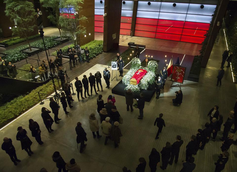 Mayor Pawel Adamowicz's coffin lies in state in the European Solidarity Centre in Gdansk, Poland, Thursday, Jan. 17, 2019. Residents of a Polish city are paying respects at the coffin of the longtime mayor who was killed in a stabbing attack. Gdansk Mayor Pawel Adamowicz will lie in state until Friday at a museum is devoted to the history of Poland’s anti-communist Solidarity movement, which started in the city. (AP Photo/Wojciech Strozyk)