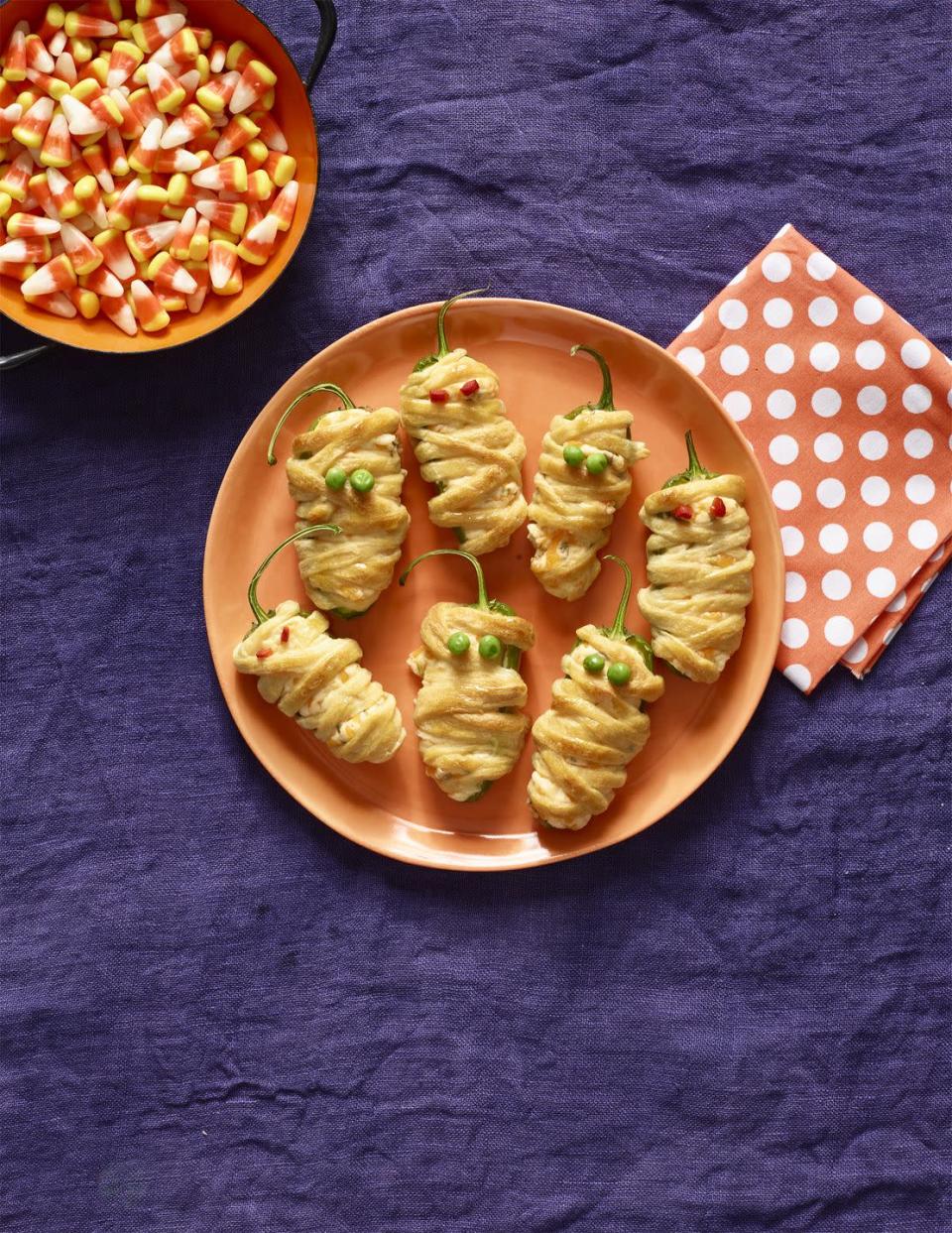 <p>To make this recipe, wrap jalapeño poppers with puff pastry and add roasted red pepper for eyes.</p><p>Get the <a href="https://www.womansday.com/food-recipes/food-drinks/recipes/a56191/hot-pepper-mummies-recipe/" rel="nofollow noopener" target="_blank" data-ylk="slk:Hot Pepper Mummies recipe" class="link "><strong>Hot Pepper Mummies recipe</strong></a>.</p><p><a class="link " href="https://www.amazon.com/Franks-RedHot-Original-Cayenne-Pepper/dp/B000XGGX6G?tag=syn-yahoo-20&ascsubtag=%5Bartid%7C10070.g.2574%5Bsrc%7Cyahoo-us" rel="nofollow noopener" target="_blank" data-ylk="slk:Shop Hot Sauce">Shop Hot Sauce</a></p>
