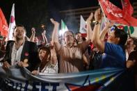 People celebrate in Athens after partial results from the referendum show a big 'No' majority