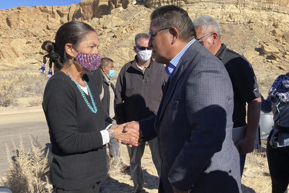 FILE - Hopi Vice Chairman Clark Tenakhongva, right, talks to UnitedStates Interior Secretary Deb Haaland after a celebration at Chaco Culture National Historical Park in northwestern New Mexico, Nov. 22, 2021. The Biden administration's approval of oil leases in a corner of New Mexico that has become a battleground over increased development and preservation of Native American sites has prompted another legal challenge. (AP Photo/Susan Montoya Bryan, File)