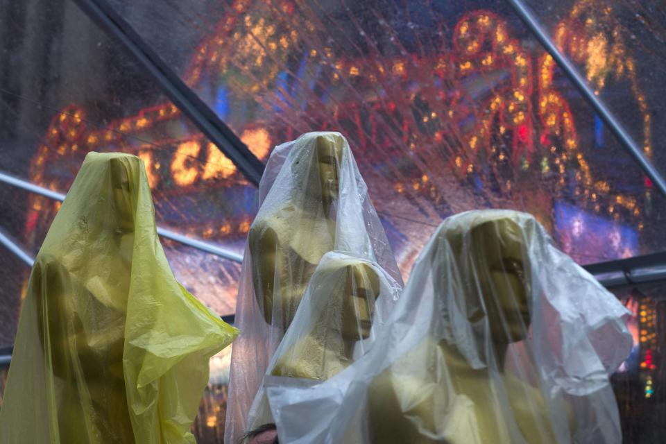 Covered Oscars statues rest under a tent, to guard against rain, along the red carpet ahead of the 86th Academy Awards in Hollywood, California