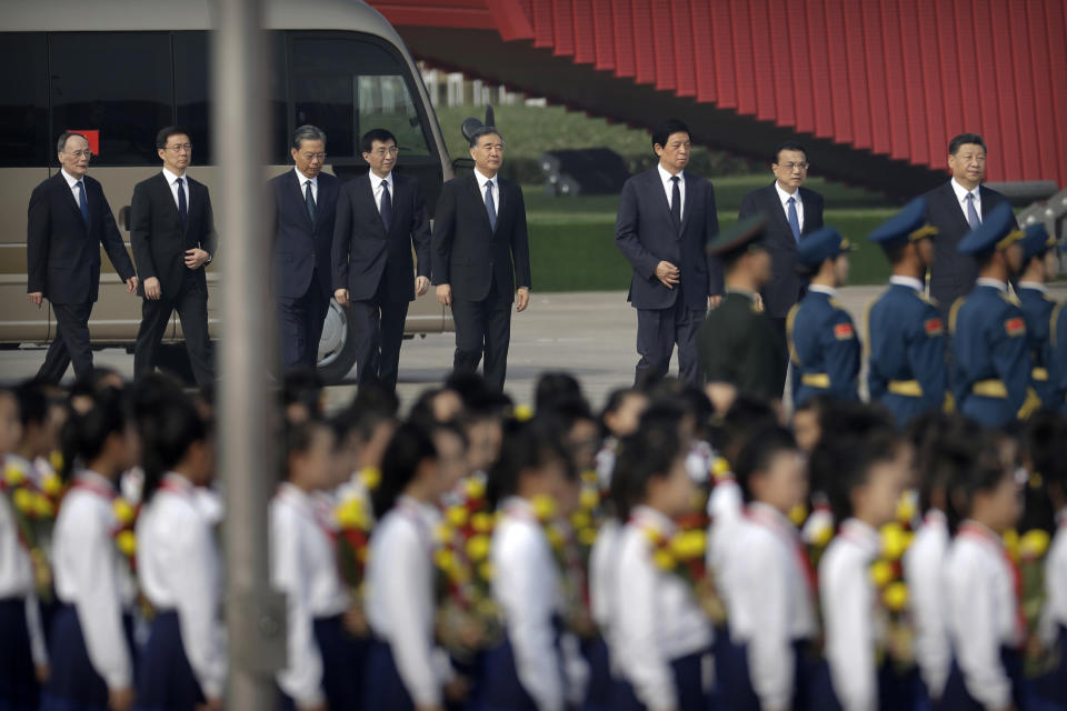 Chinese President Xi Jinping, right, and members of the Politburo Standing Committee, from left, Wang Qishan, Han Zheng, Zhao Leji, Wang Huning, Wang Yang, Li Zhanshu and Li Keqiang, arrive for a ceremony to mark Martyr's Day at Tiananmen Square in Beijing, Monday, Sept. 30, 2019.Xi led other top officials in paying respects to the founder of the communist state Mao Zedong ahead of a massive celebration of the People's Republic's 70th anniversary. (AP Photo/Mark Schiefelbein, Pool)