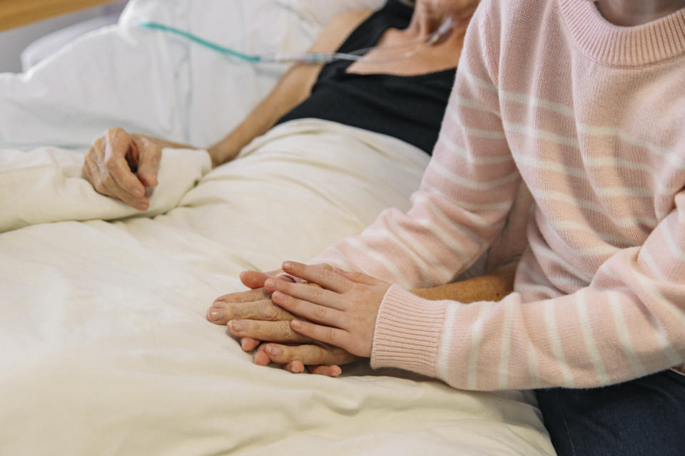 Comforting woman in hospital after a stroke. (Getty Images)