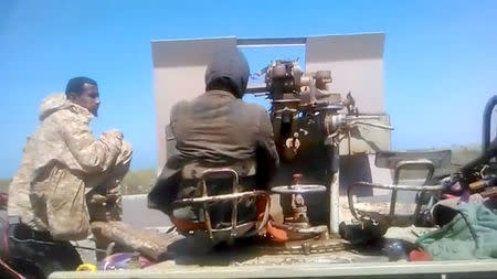 Members of UAE-backed fighters, Yemeni Resistance Giants' Brigade sit with the gun at the back of truck, near airport on the outskirts of Hodeidah, Yemen, June 19, 2018 in this still image taken from video. YEMENI RESISTANCE GIANTS' BRIGADE/REUTERS