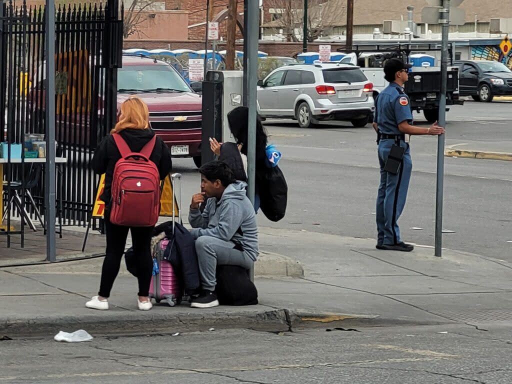 A group of people sitting on a pavement