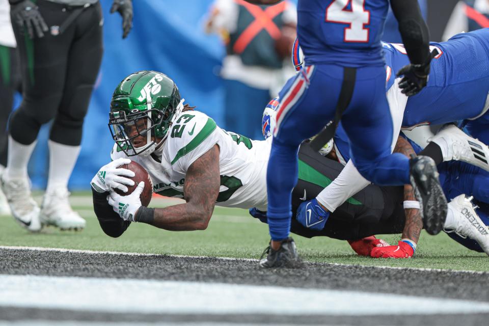 Nov 6, 2022; East Rutherford, New Jersey, USA; New York Jets running back James Robinson (23) scores a touchdown  during the second half in front of Buffalo Bills safety Jaquan Johnson (4) at MetLife Stadium. Mandatory Credit: Vincent Carchietta-USA TODAY Sports