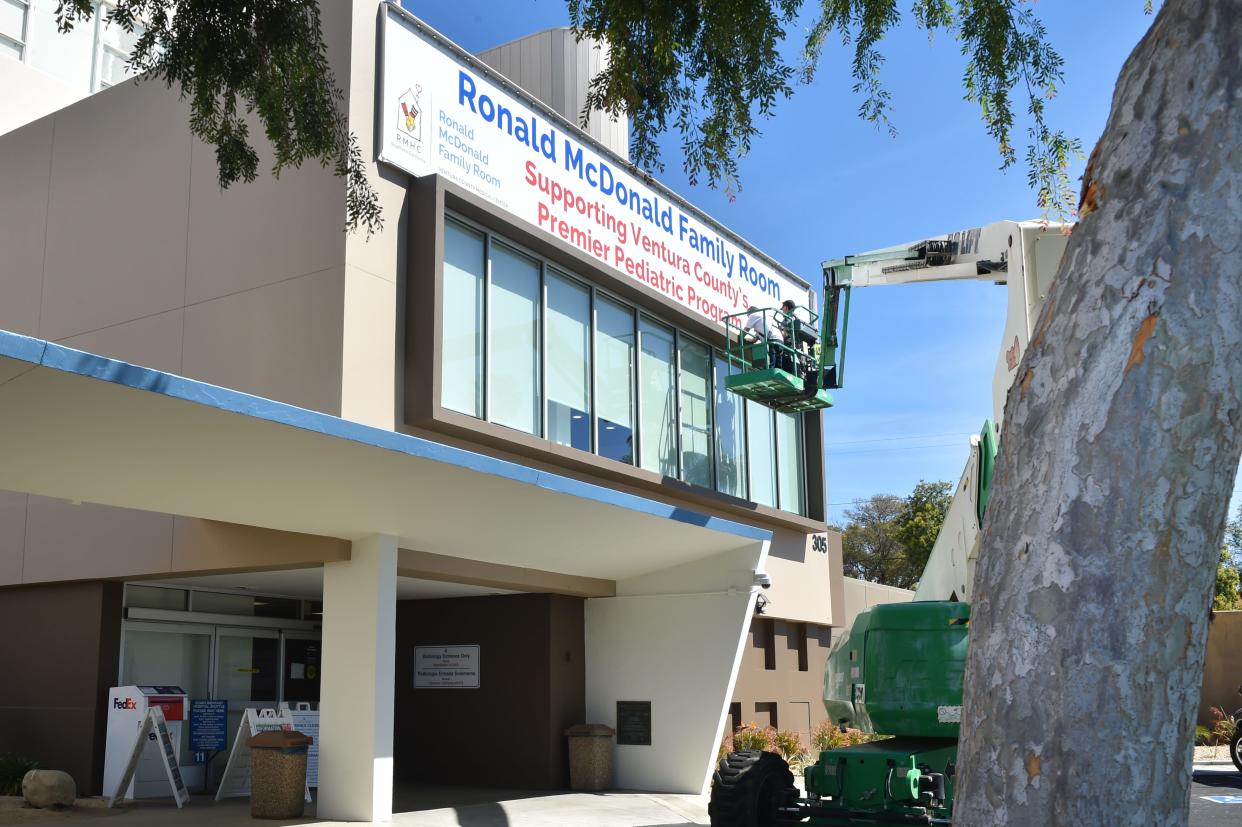 A crew installs a banner announcing the development of the Ronald McDonald Family Room at Ventura County Medical Center in Ventura in this March file photo. The College Area Community Council will discuss the programs offered at the room at its meeting Wednesday.