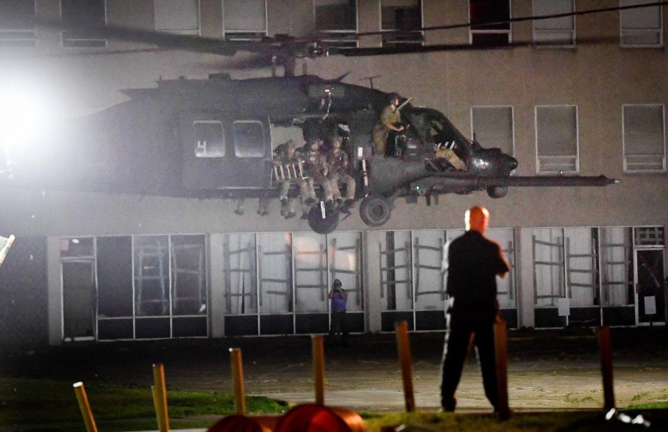 Troops are lifted off from the parking lot of the old IBT church building on Second Street in Henderson after a training exercise Thursday night complete with flash-bang grenades and fake gunfire.