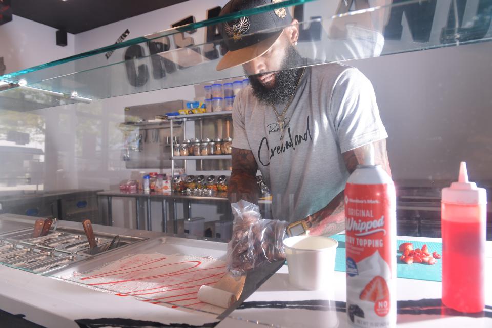 Aldren P. Abraham is the owner of Creamland ice cream shop in
Anderson. Here, Abraham works the ingredients to create on of his specialty ice cream treats on the menu.