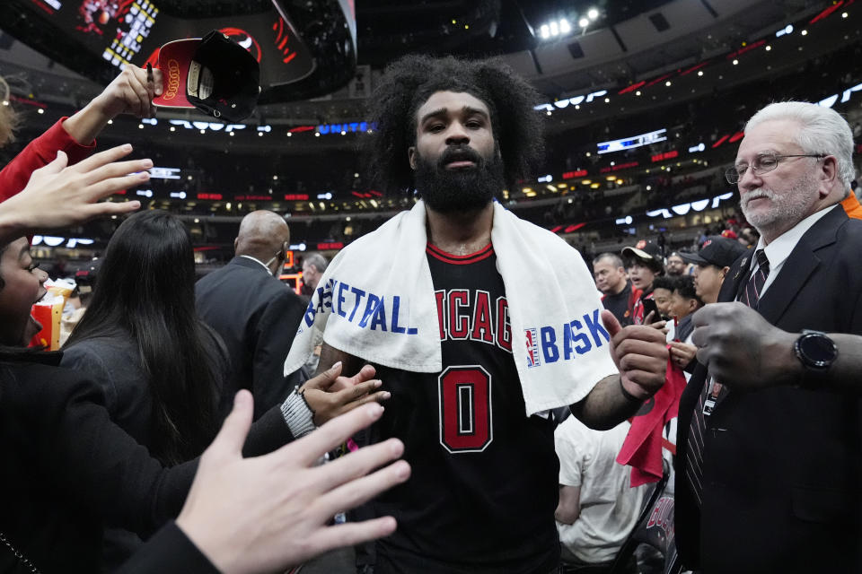 Fans reach out to Chicago Bulls guard Coby White after the Bulls defeated the Atlanta Hawks 131-116 in an NBA basketball play-in tournament game in Chicago, Wednesday, April 17, 2024. (AP Photo/Nam Y. Huh)