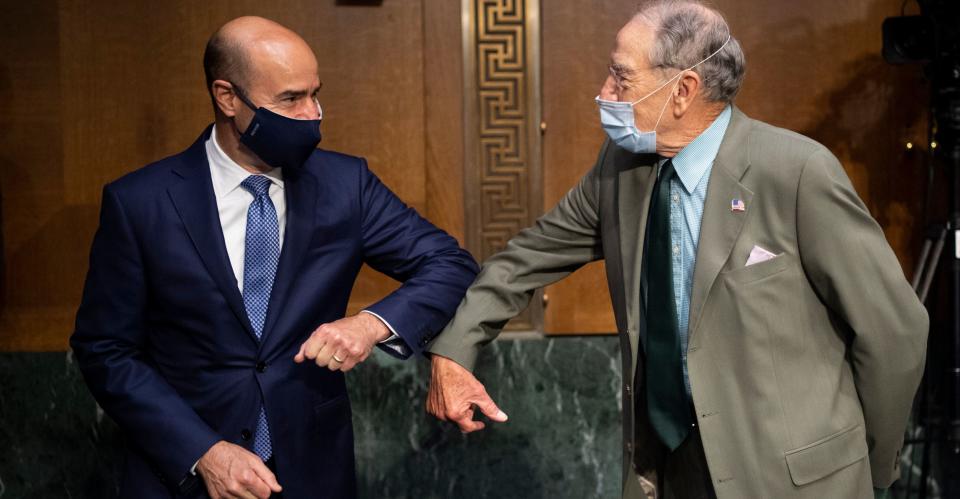 Labor Secretary Eugene Scalia, left, elbow bumps Sen. Chuck Grassley (R-Iowa) before the start of a Senate Finance Committee hearing on COVID-19 unemployment insurance in Washington on June 9. (Photo: Caroline Brehman via Getty Images)