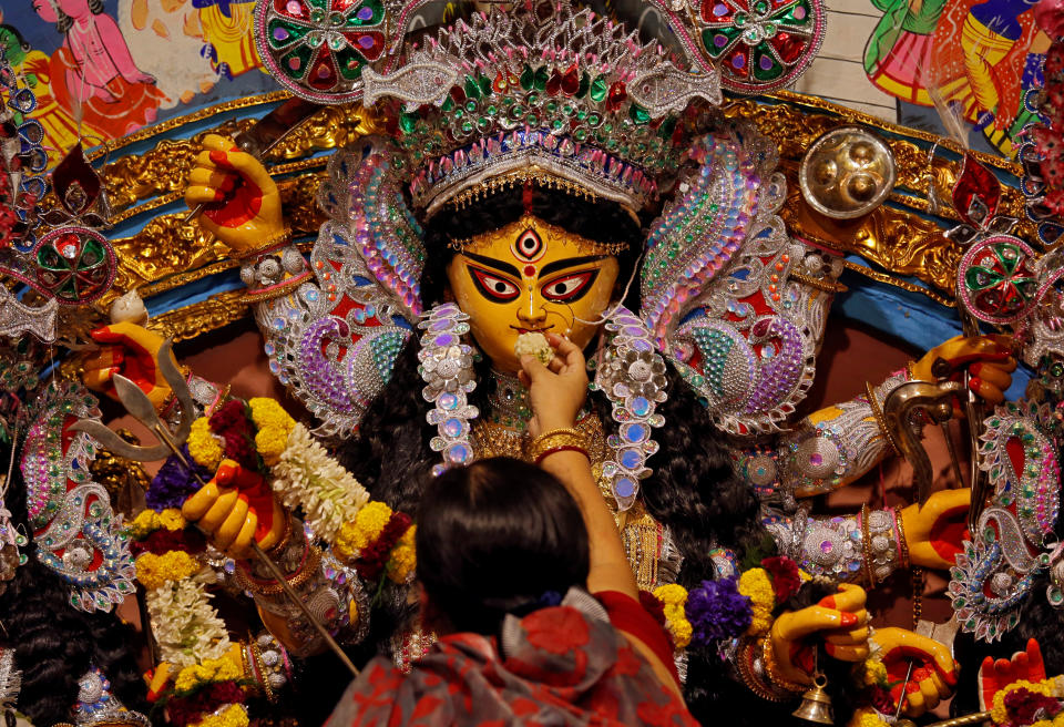 <p>A devotee offers sweets to an idol of the Hindu goddess Durga while offering prayers on the last day of the Durga Puja festival in Kolkata, India, Sept. 30, 2017. (Photo: Rupak De Chowdhuri/Reuters) </p>