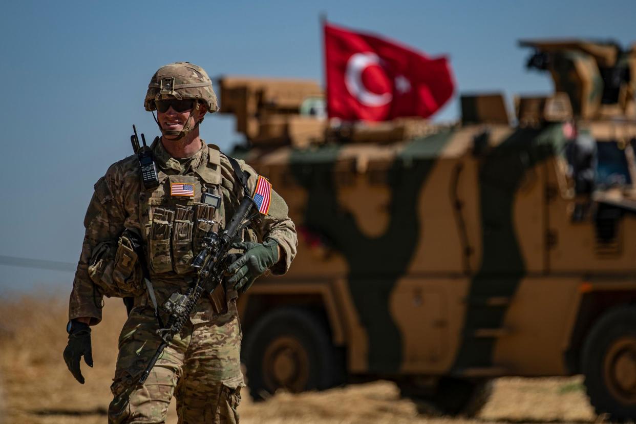 A US soldier stands guard during a joint patrol with Turkish troops in the Syrian village of al-Hashisha on the outskirts of Tal Abyad: DELIL SOULEIMAN/AFP/Getty Images