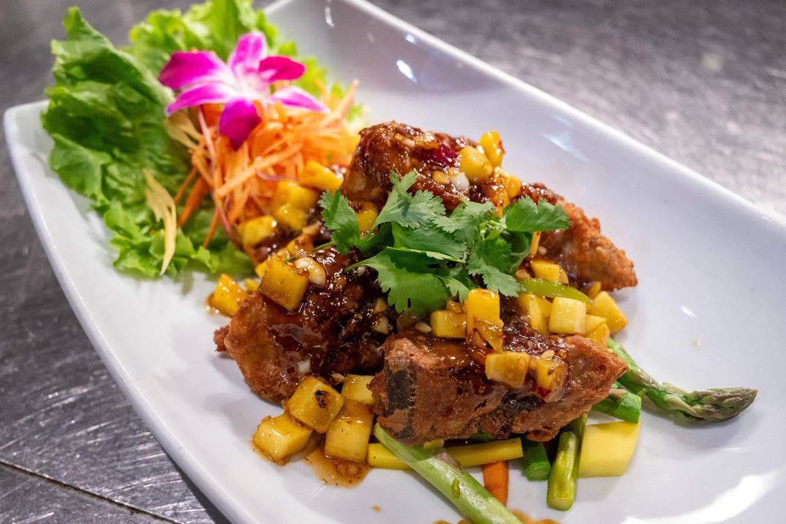 Bamboo Penny’s mango duck dish is deboned, lightly fried and layered in a bed of mangoes, sautéed asparagus and heirloom carrots. It is dressed in a house-made sauce with fresh diced mango, onions, bell peppers and garnished with an orchid flower and cilantro.