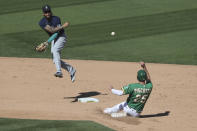 Seattle Mariners' J.P. Crawford, left, throws to first as Oakland Athletics' Stephen Piscotty slides into second on a double play hit by Jake Lamb during the seventh inning of the first baseball game of a doubleheader in Oakland, Calif., Saturday, Sept. 26, 2020. (AP Photo/Jed Jacobsohn)