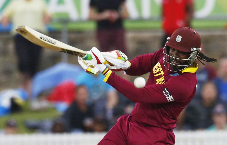 West Indies batsman Chris Gayle plays the ball to the boundary during their World Cup Cricket match against Zimbabwe in Canberra, February 24, 2015. REUTERS/David Gray (AUSTRALIA - Tags: SPORT CRICKET)