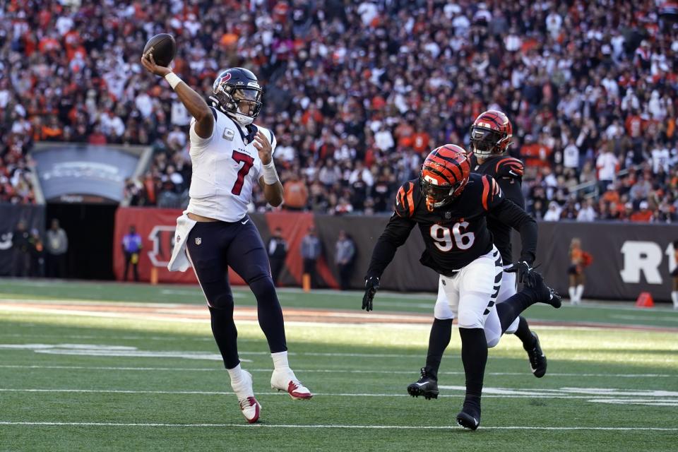 Houston Texans quarterback C.J. Stroud (7) throws a pass as Cincinnati Bengals defensive end Cam Sample (96) defends during the second half of an NFL football game Sunday, Nov. 12, 2023, in Cincinnati. (AP Photo/Michael Conroy)