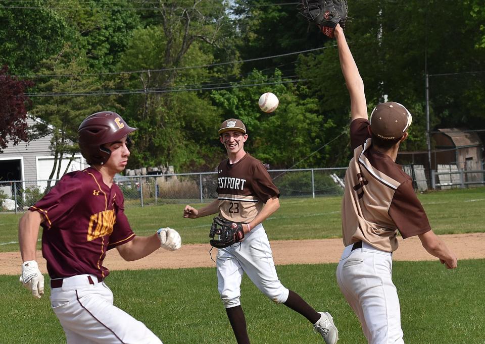 Case's Ben Duquette is safe at first as the ball sails past Luke Finglas. Second baseman William Souza look on.