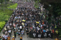 Protesters march with a banner that reads: "Police authority is too big" in Hong Kong Saturday, Aug. 3, 2019. Hong Kong protesters ignored police warnings and streamed past the designated endpoint for a rally Saturday in the latest of a series of demonstrations targeting the government of the semi-autonomous Chinese territory. (Steve Leung/HK01 via AP)