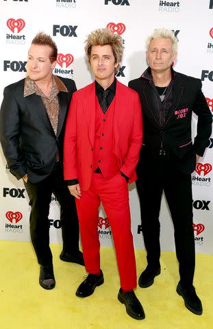 <p>Jesse Grant/Getty</p> Tré Cool, Billie Joe Armstrong and Mike Dirnt of Green Day at the iHeartRadio Music Awards at The Dolby Theater in Los Angeles on April 1, 2024