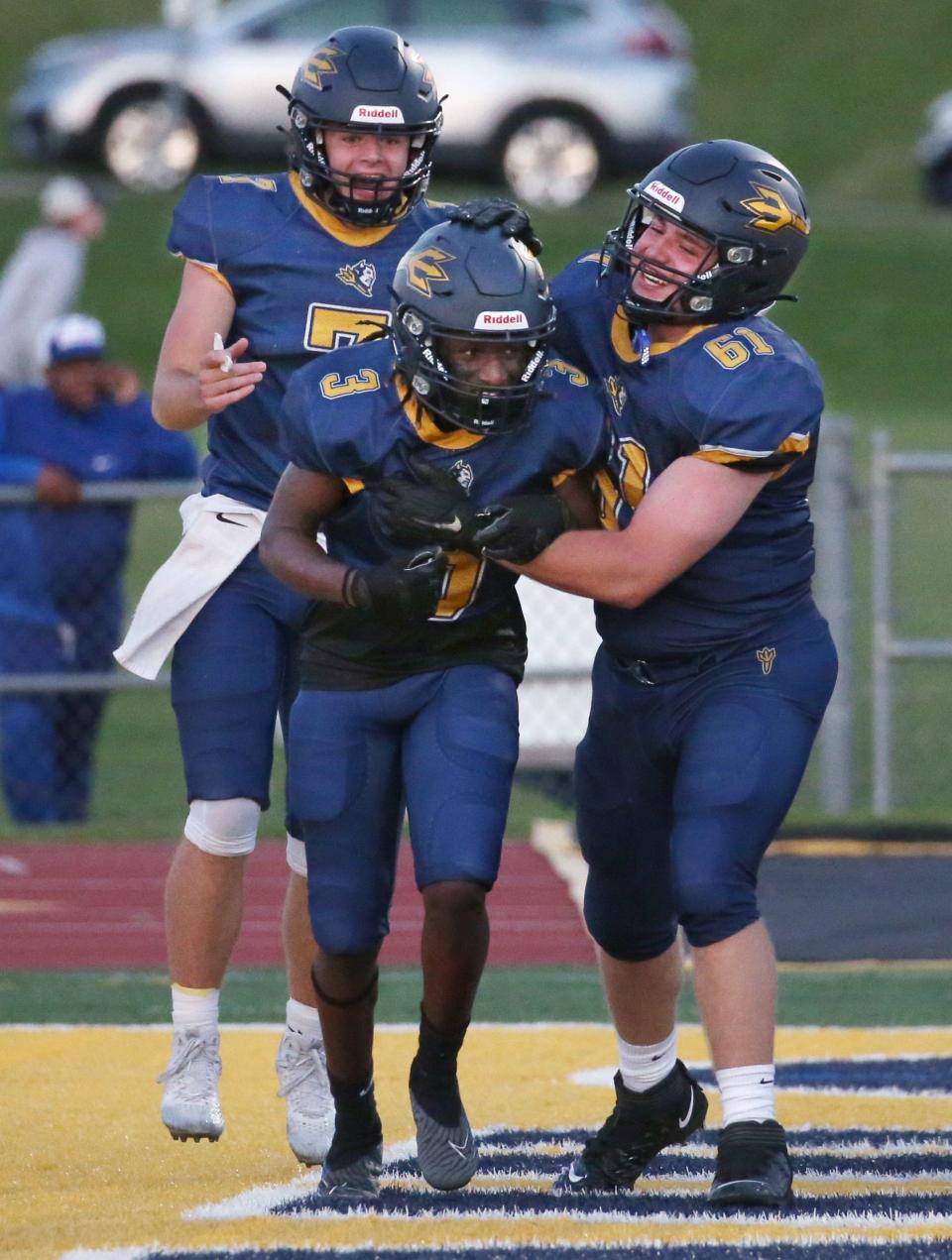 Victor running back Eric Young celebrates his first half touchdown with teammates Jacob Loughlin and Connor Doran. Victor won the contest 41-14.