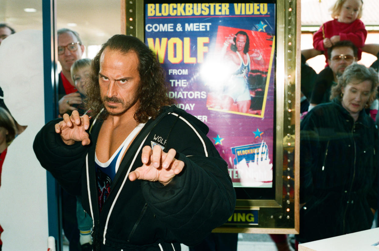 Wolf from Gladiators opening the new Blockbuster Video in Reading, 6th November 1994. (Photo by Staff/Mirrorpix/Getty Images)