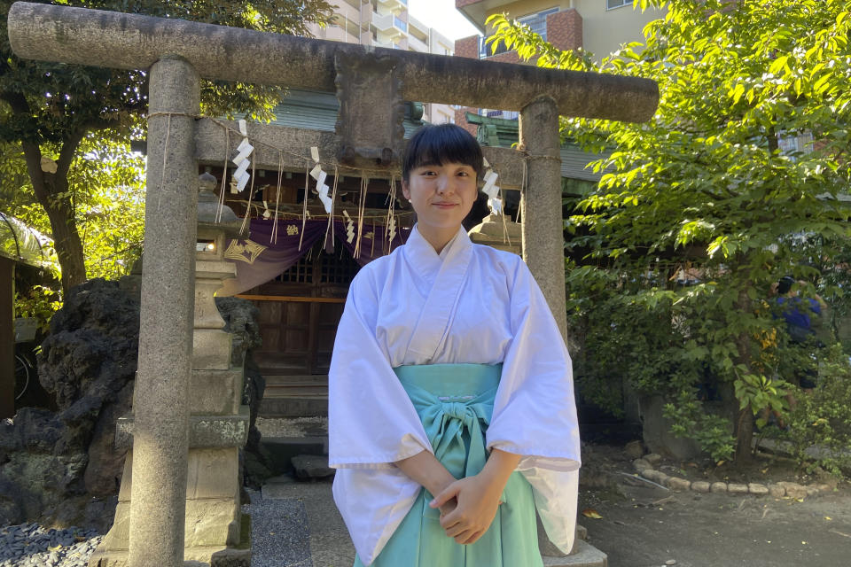 Karin Kodashima, a priest at Onoterusaki Jinja, poses for a photo during an interview with The Associated Press at the shrine in downtown Tokyo on Monday, Sept. 18, 2023. Kodashima talks about the growing popularity of the Goshuin stamps, a certificate of visit, and the role of Shinto shrines in a country where religions often serve more as connections to family and community than as theological guides as in the West. (AP Photo/Mari Yamaguchi)