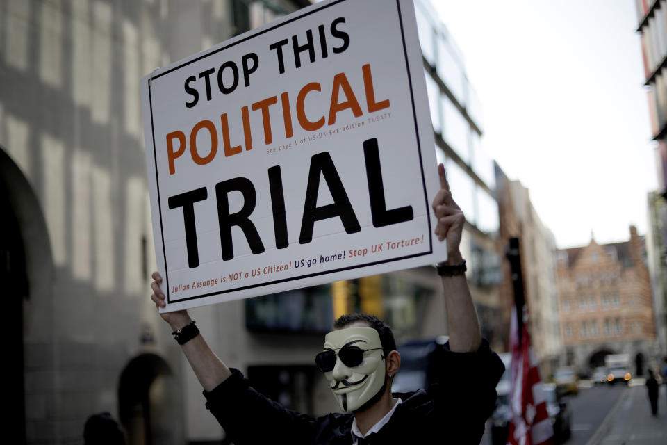 A supporters of WikiLeaks founder Julian Assange takes part in a protest outside the Central Criminal Court, the Old Bailey, in London, Monday, Sept. 14, 2020. The London court hearing on Assange's extradition from Britain to the United States resumed Monday after a COVID-19 test on one of the participating lawyers came back negative, WikiLeaks said Friday. (AP Photo/Matt Dunham)