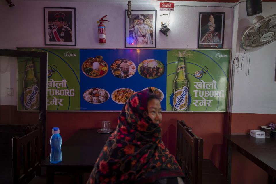 Photographs of Nepal's former kings are displayed on the wall of a restaurant in Kathmandu, Nepal, Feb. 26, 2024.. Nepal’s once unpopular monarchy — abolished after centuries of rule over the Himalayan nation — is hoping to regain some of its lost glory. Royalist groups and supporters of former King Gyanendra have been holding rallies to demand the restoration of the monarchy and the nation’s former status as a Hindu state. (AP Photo/Niranjan Shrestha)