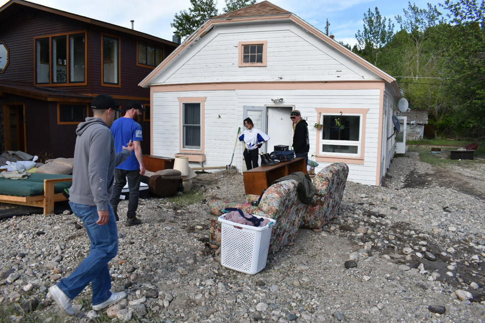 Residents of Red Lodge, Mont., inspect damage to a house that was flooded after torrential rains fell across the Yellowstone region, Tuesday, June 14, 2022. Local officials say more than 100 houses in the small city were flooded. (AP Photo/Matthew Brown)