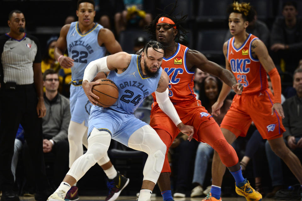 Memphis Grizzlies forward Dillon Brooks (24) handles the ball against Oklahoma City Thunder forward Luguentz Dort (5) in the first half of an NBA basketball game Thursday, Dec. 2, 2021, in Memphis, Tenn. (AP Photo/Brandon Dill)