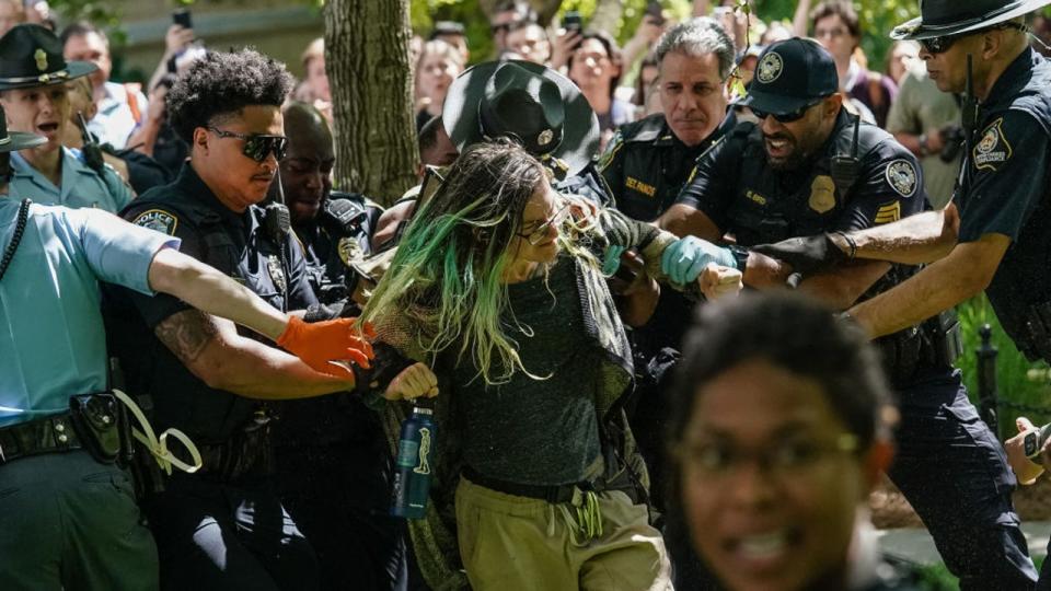<div>Police officers arrest a demonstrator during a pro-Palestinian protest against the war in Gaza at Emory University on April 25, 2024, in Atlanta. (Photo by Elijah Nouvelage / AFP) (Photo by ELIJAH NOUVELAGE/AFP via Getty Images)</div>