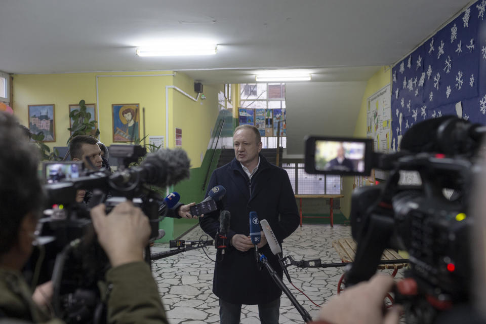 Dragan Djilas, center, the main opposition coalition leader, talks to members of the media after casting his ballots for the early local and parliamentary elections in Belgrade, Serbia, Sunday, Dec. 17, 2023. Serbia's populist President Aleksandar Vucic is looking to further tighten his firm grip on power in the Balkan state in an election on Sunday that has been marred by reports of major irregularities during a tense campaign. (AP Photo/Marko Drobnjakovic)