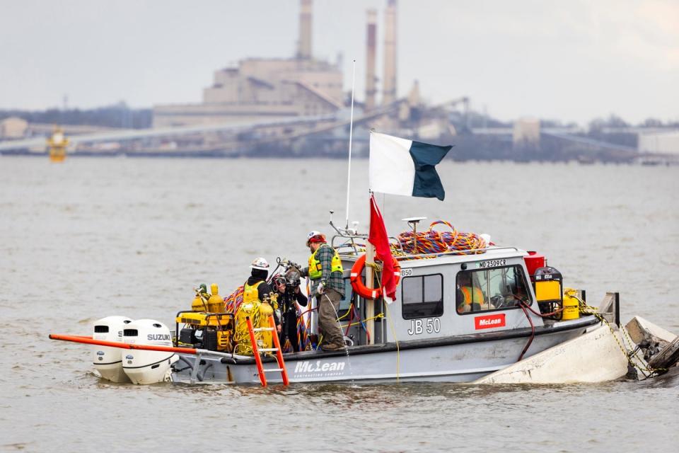 A dive crew prepares to send a diver beneath the water surrounding the collapsed Francis Scott Key Bridge in Baltimore, Maryland (EPA)