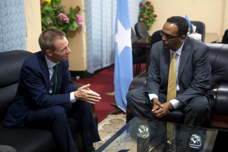 Britain's ambassador to Somalia, Neil Wigan (left), speaks with Somalia's Deputy Prime Minister Mohamed Omar Arte during a visit to Villa Somalia, the fortified government quarter in Mogadishu, on February 18, 2015