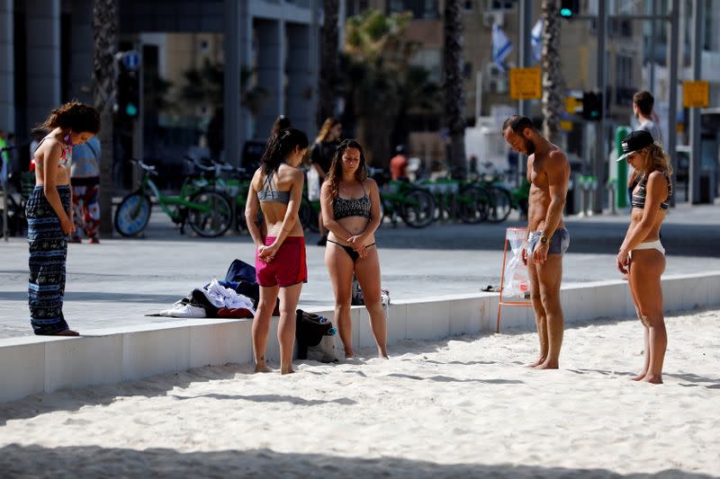 People stand still as a two-minute siren marking the annual Israeli Holocaust Remembrance Day is heard in Tel Aviv