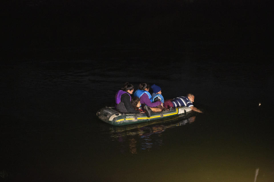 A smuggler takes migrants, mostly from Central American countries, on a small inflatable raft towards U.S. soil in Roma, Texas, Wednesday, March 24, 2021. A surge of migrants on the Southwest border has the Biden administration on the defensive. The head of Homeland Security acknowledged the severity of the problem but insisted it's under control and said he won't revive a Trump-era practice of immediately expelling teens and children. (AP Photo/Dario Lopez-Mills)