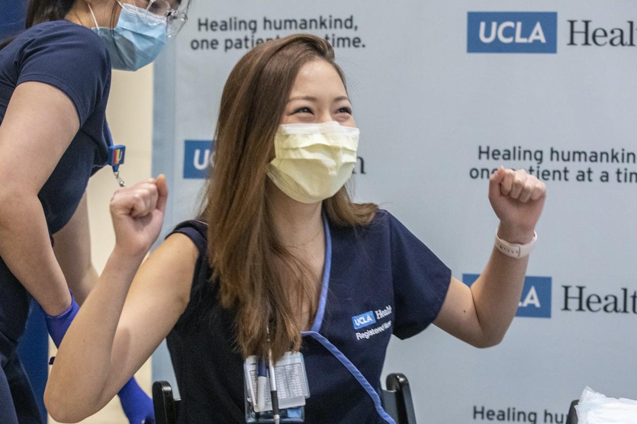 <span class="caption">Nurse Nicole Chang celebrates after receiving one of the first injections of the COVID-19 vaccine Dec. 16 at Ronald Reagan UCLA Medical Center in Westwood, California. </span> <span class="attribution"><a class="link " href="https://www.gettyimages.com/detail/news-photo/nurse-nicole-chang-celebrates-after-receiving-one-of-the-news-photo/1230161645?adppopup=true" rel="nofollow noopener" target="_blank" data-ylk="slk:Brian van der Brug/Getty Images;elm:context_link;itc:0;sec:content-canvas">Brian van der Brug/Getty Images</a></span>