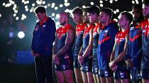 Melbourne Demons players mark the occasion.