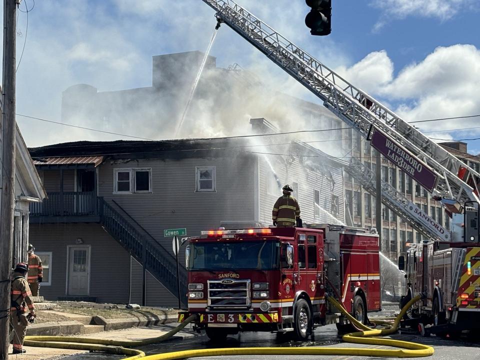 Firefighters drench the two-story structure that caught fire at 29 River Street in Sanford, Maine, on Thursday, March 21, 2024. They battled high and unhelpful winds too.