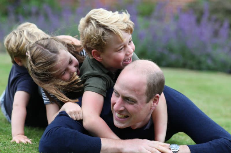 Another shot also showed the royal dad playing with his kids in the grounds of Anmer Hall in Norfolk (Getty Images)